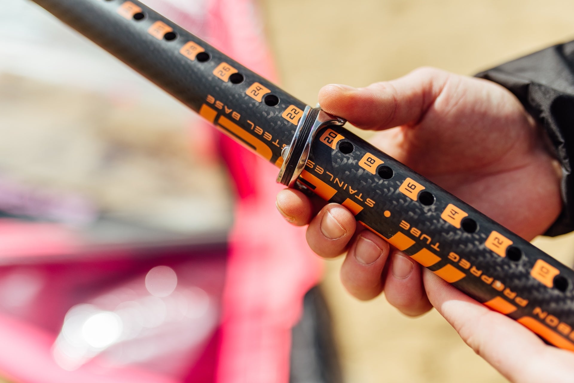 someone holding a windsurf extension made from carbon fiber