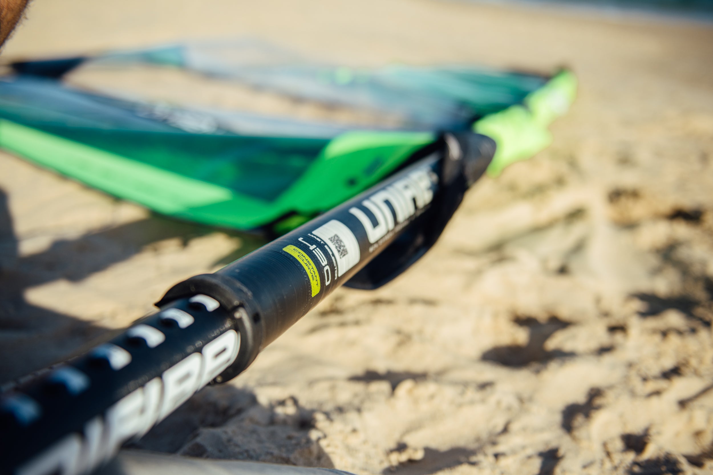 close up picture of a windsurf mast on the beach and the junction with the extension